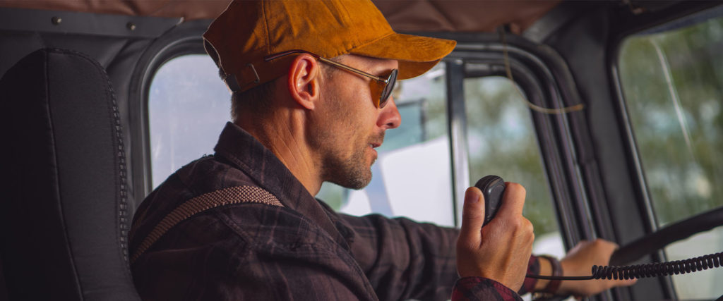 Trucker using radio to communicate on the road