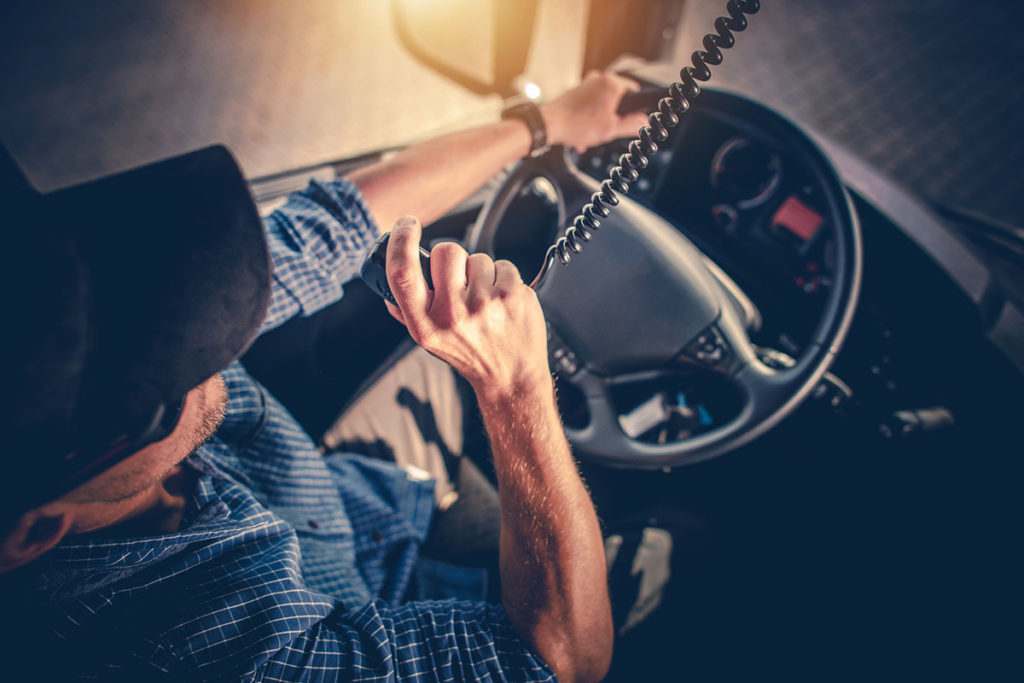 Trucker using radio to communicate easily while driving